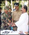 EDPD representativ handing over weapon to Sri Lanka Army