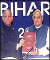 Indian Prime Minister, A.B. Vajpayee with Mr L.M. Singhvi, holding together the NRI report